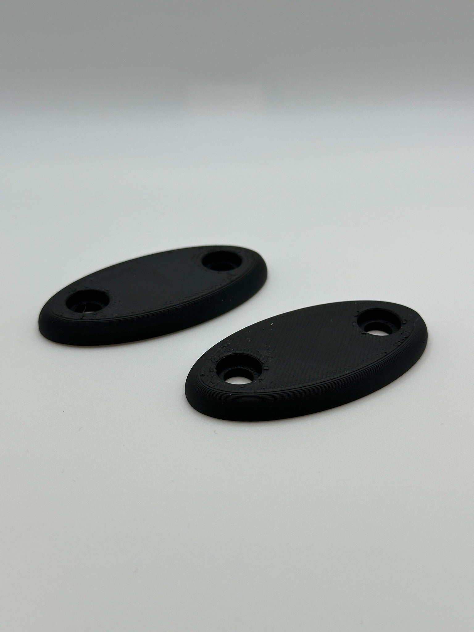 Set van twee zwarte ovale plaatjes, 3D-geprint voor veelzijdig gebruik.